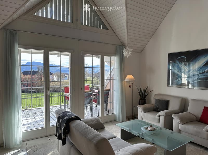 large windows, sliding glass doors, balcony, table, chairs, sofa, armchairs, coffee table, lamp, plant, painting