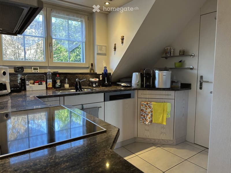 modern kitchen with granite countertops, white cabinets, stainless steel appliances, large window, tiled floor