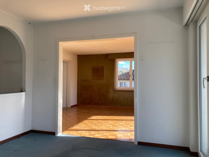 empty room, wooden floor, white walls, window on the right, open door leading to another room