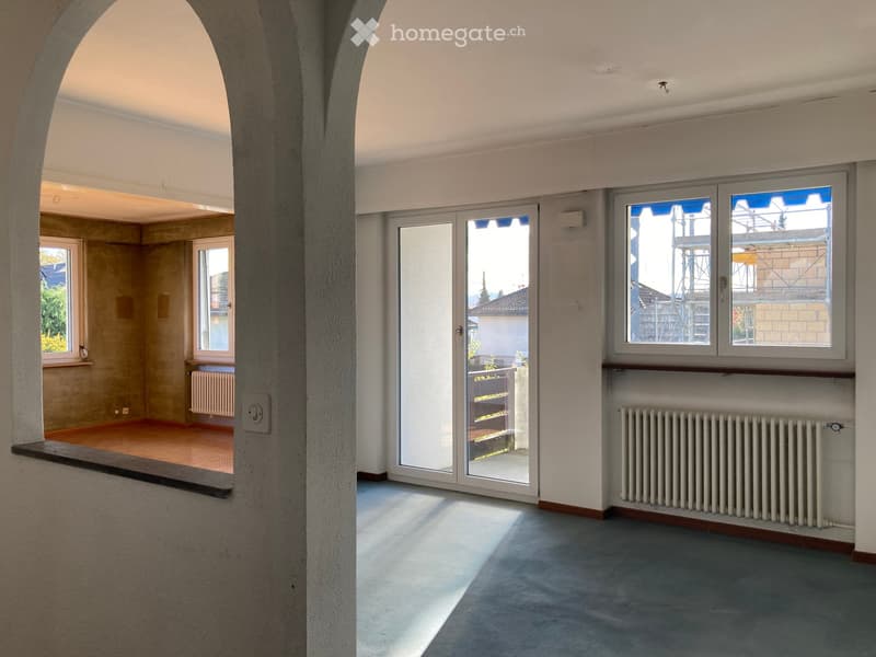 empty room, large windows, balcony, arched window, two radiators