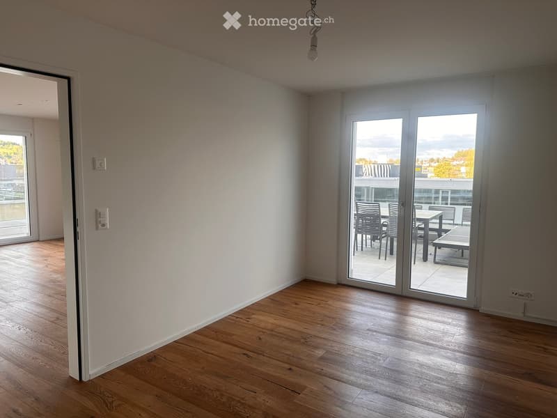 empty room, wooden floor, white walls, sliding glass doors, balcony with outdoor furniture, view of the outside
