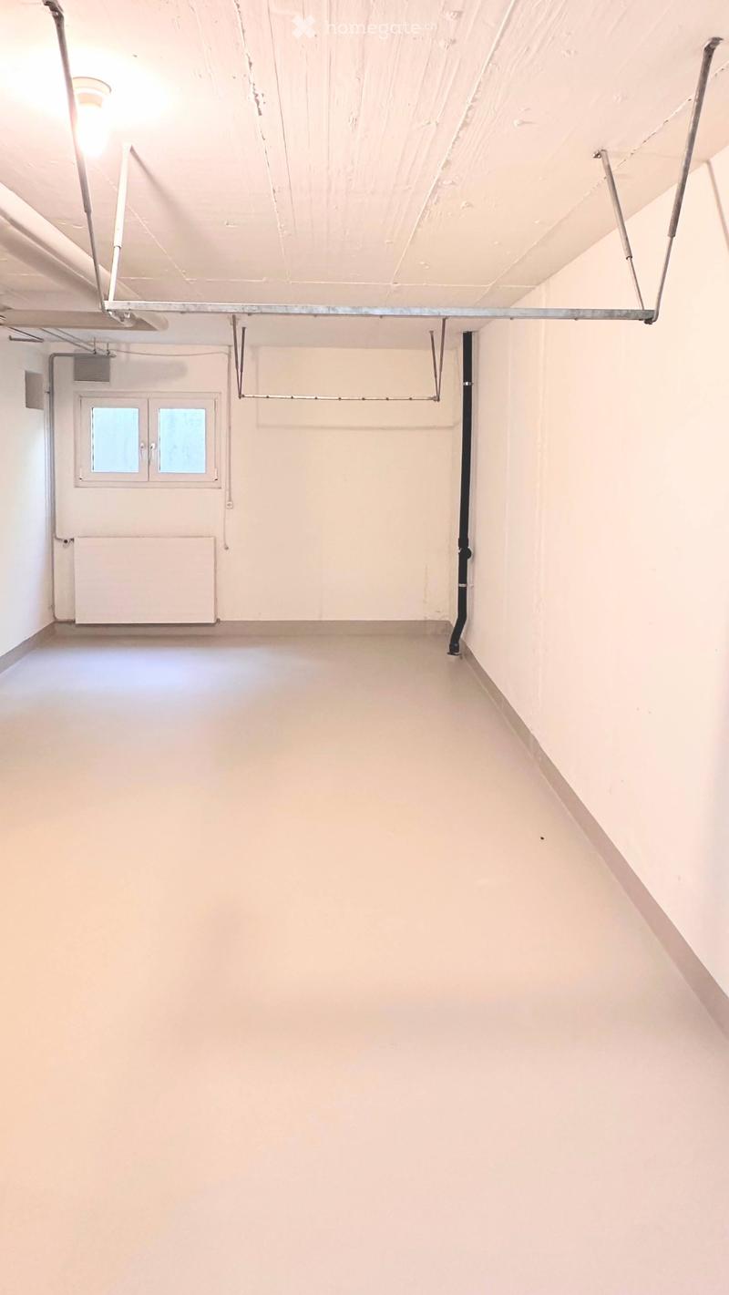 Empty room with white walls, a single window, and a radiator. No furniture or equipment present.