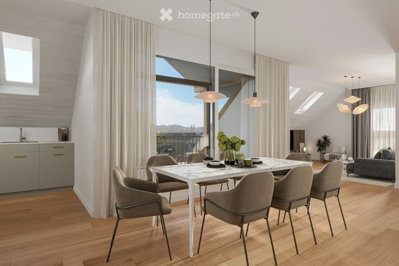Modern, open-concept dining and living area with wooden flooring, white dining table with six chairs, grey sofa, pendant lights, and a kitchen area with cabinets and a sink.