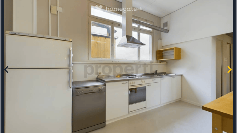 modern kitchen with white cabinets, stainless steel appliances, wooden table, large windows