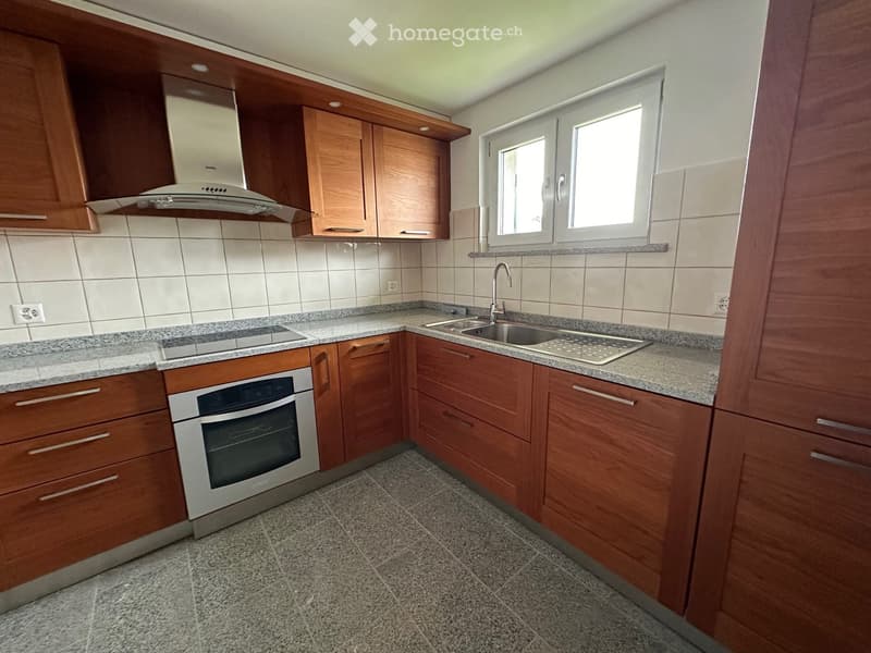 wooden cabinets, stainless steel appliances, granite countertop, under cabinet lighting, sink, faucet, windows