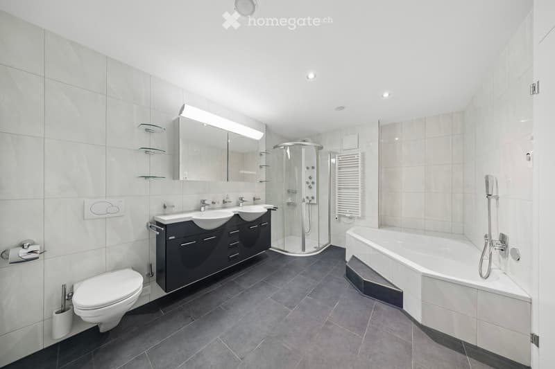 Bathroom. Modern bathroom with white tiles, gray floor, two sinks, a shower, and a bathtub.