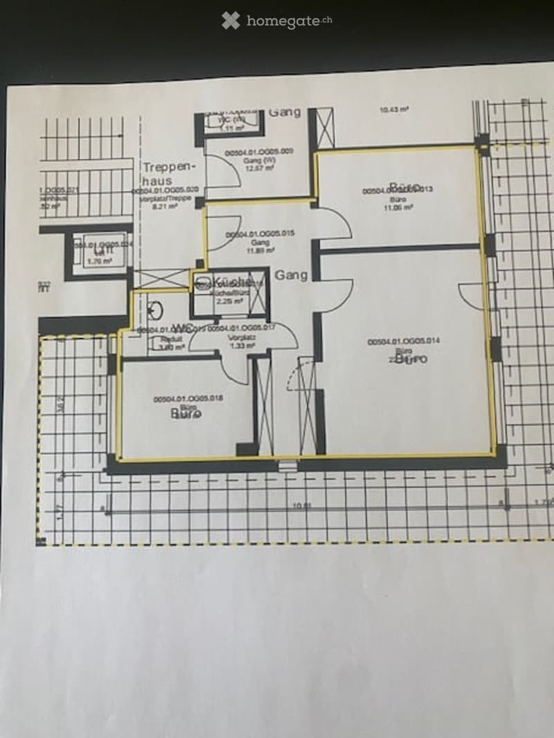 Floor plan of a residential space showing a staircase, kitchen, living room, and hallway.