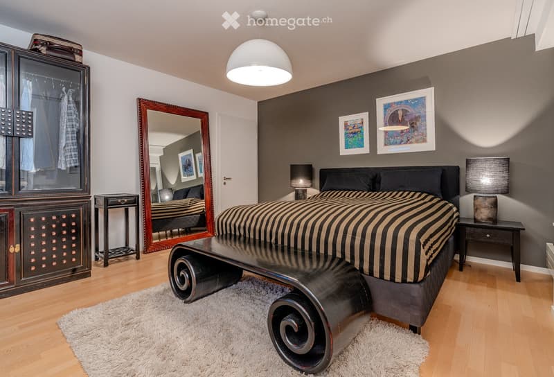 Modern bedroom with a large bed, nightstands, a wardrobe, a mirror, and a stylish lamp.