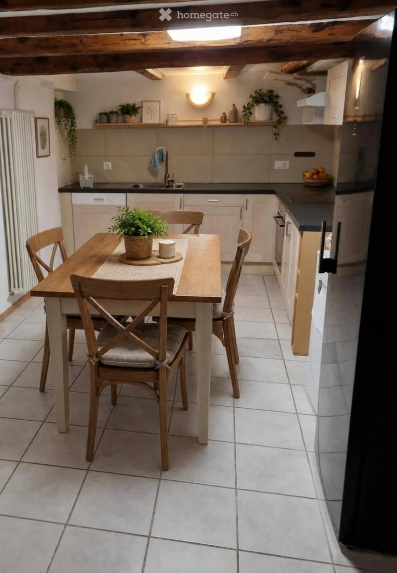 Cozy kitchen with a wooden dining table and four chairs, white tiled floor, modern cabinets, and a sink with a faucet. Shelves hold decorative items and plants.