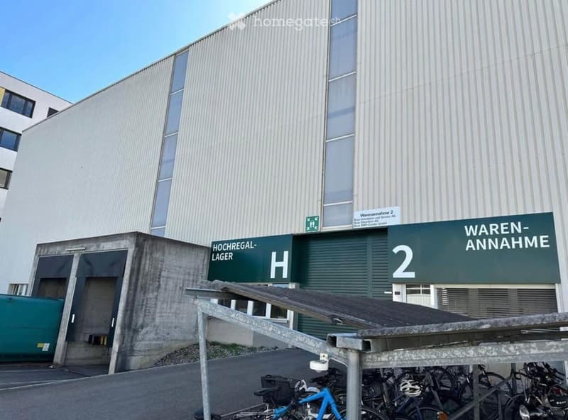 Industrial building with a large loading dock, bicycles parked in front.