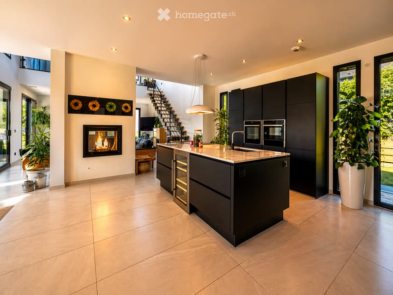 modern kitchen with island, fireplace, large windows, modern appliances, tiled floor