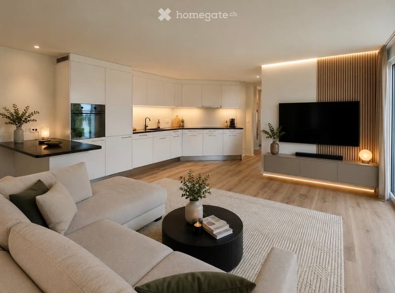 Modern open-plan living and dining area with a white sofa, coffee table, TV, and a sleek kitchen with white cabinets and stainless steel appliances.