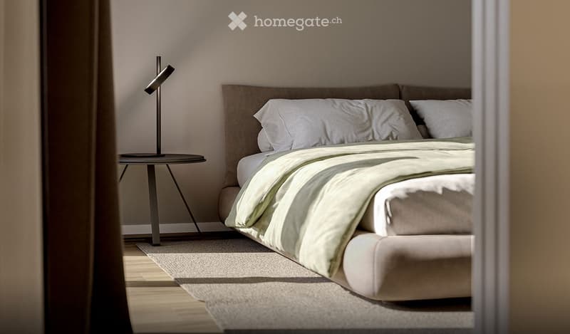Modern bedroom with a large bed, white bedding, a nightstand, and a sleek lamp. The room features light-colored walls and wooden flooring.