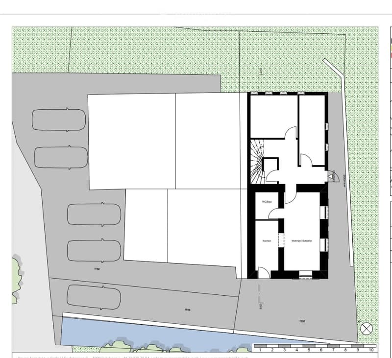 Floor plan of a residential building showing a parking area with multiple parking spaces, a WC/Bad, a kitchen, and a Wohnraum Schlaf (living room/bedroom).