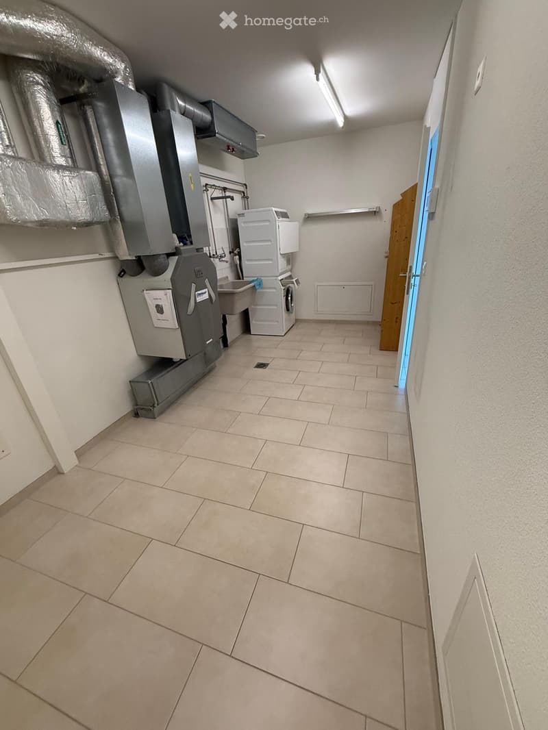 Laundry room with tiled floor, white walls, washing machine, dryer, and air conditioning unit.