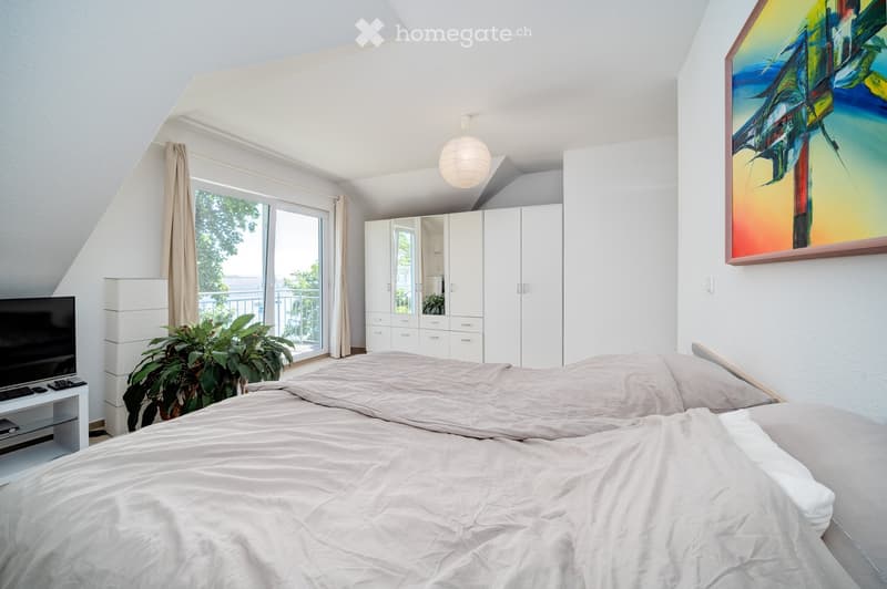 double bed, nightstands, wardrobes, large windows, balcony, painting on wall, TV, curtains
