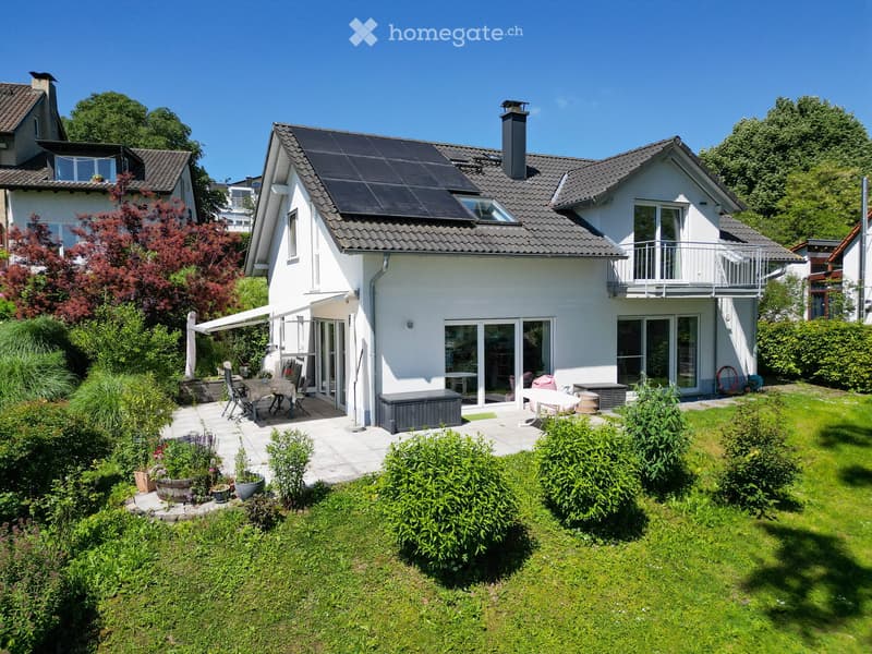modern white house, solar panels, garden, balcony, patio with outdoor furniture