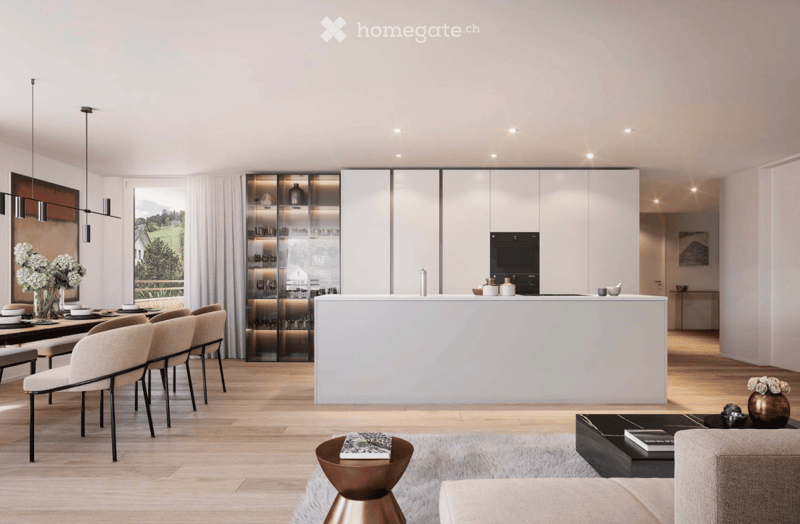 Modern open-plan living and dining area with a kitchen island, pendant lights, sleek chairs, and a cozy seating area with a sofa and coffee table.