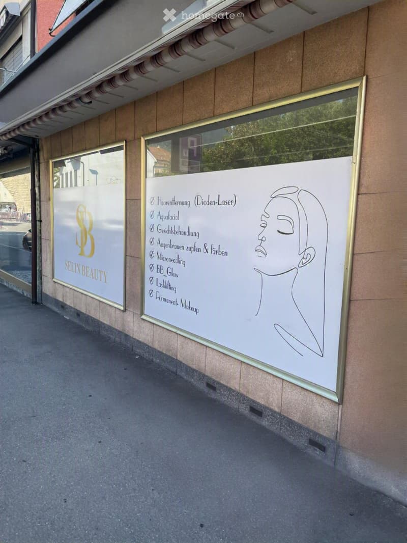 Exterior view of a building with two large glass windows displaying advertisements for a beauty salon named "Selin Beauty" and a list of services including hair removal, facial treatments, and permanent makeup.