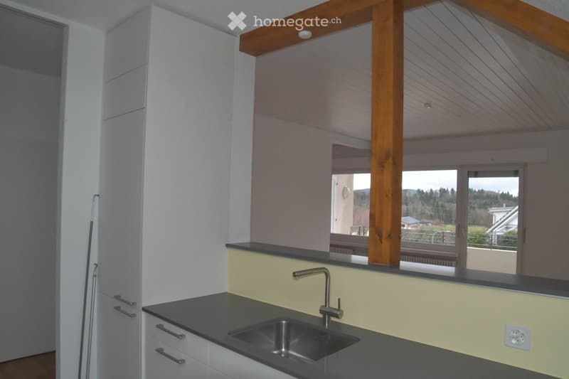 kitchen with sink, faucet, cabinets, wooden beam, balcony, window, view of the outside