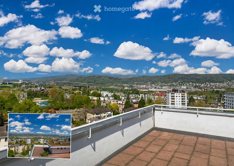 Roof terrace with a panoramic view of a cityscape, distant hills, and a partly cloudy sky.
