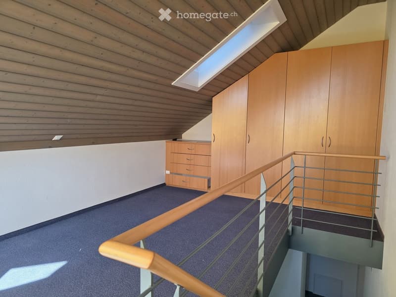 Modern hallway with wooden ceiling, built-in wardrobes, and a staircase with wooden handrail and metal balustrade.