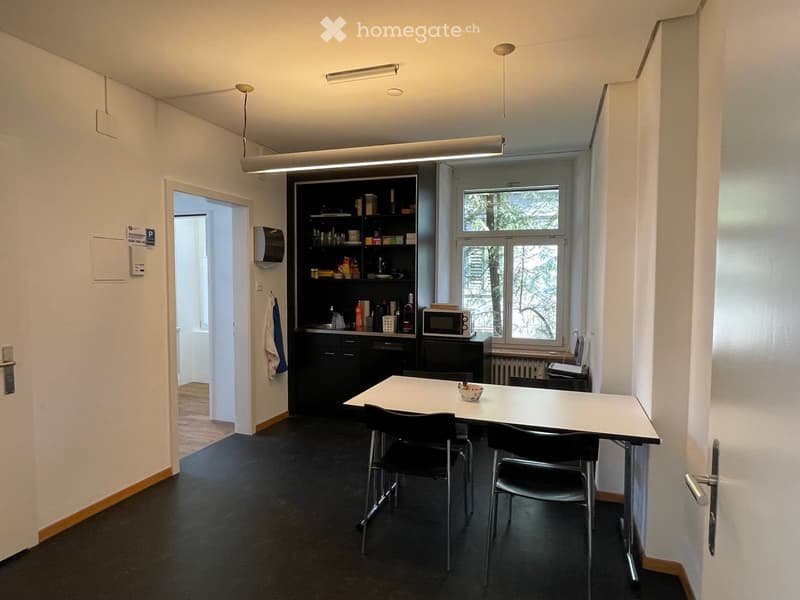 a compact kitchenette with a microwave, a refrigerator, and a sink