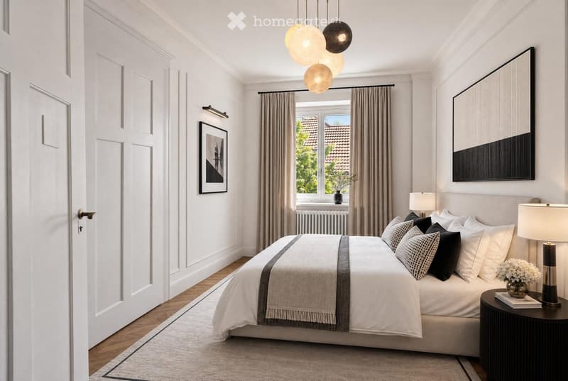 Modern bedroom with a large bed, nightstand, lamp, and artwork on the walls. The room features wooden flooring, large windows with curtains, and a cozy ambiance.