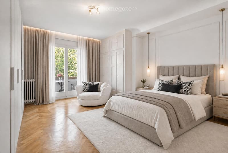 Elegant bedroom with a large bed, nightstand, round chair, and a small table with a vase of flowers near the window. The room features wooden flooring, white walls, and modern lighting fixtures.