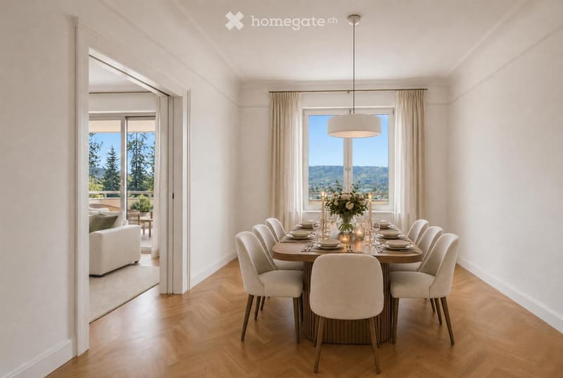 Elegant dining room with a wooden dining table, upholstered chairs, a flower centerpiece, and candles. Large windows offer a scenic mountain view, and a white sofa is visible in the adjacent living area.
