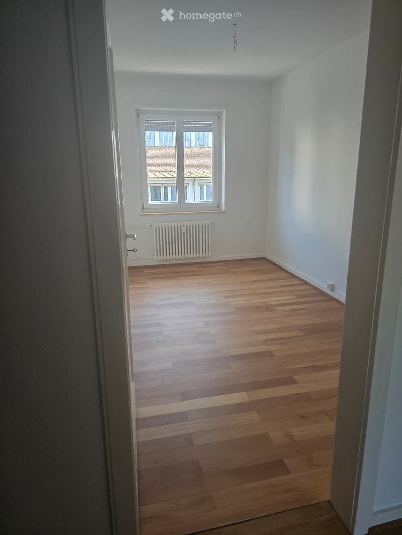 empty room, hardwood floor, white walls, window, white radiator