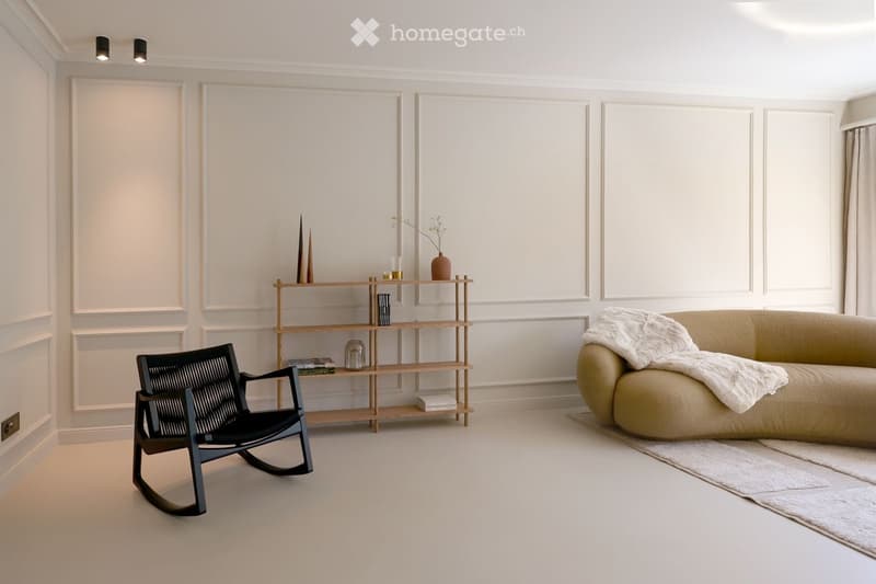 modern living room with white walls, black rocking chair, wooden shelf, beige sofa, white rug