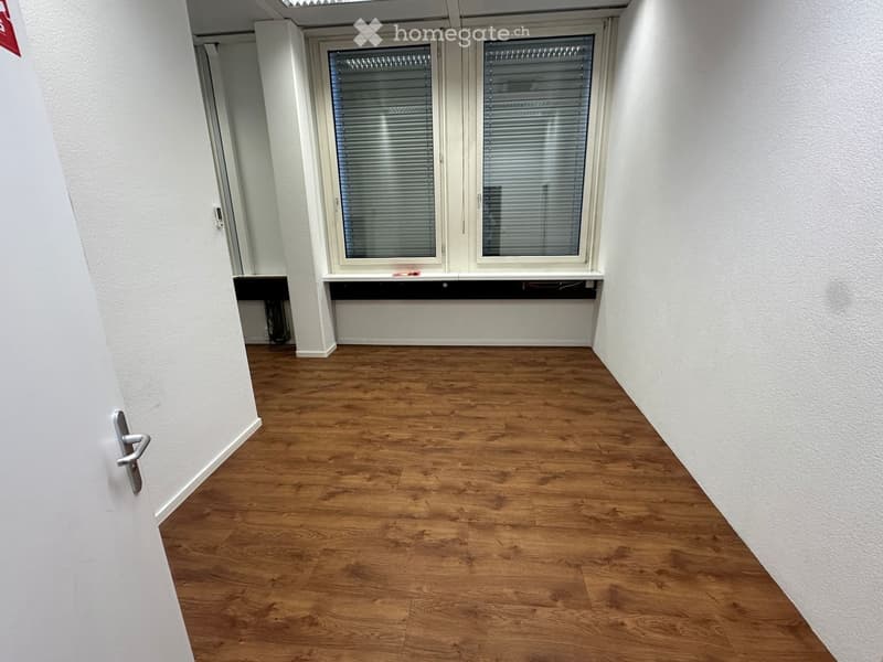 empty room, wooden floor, white walls, two windows with blinds, door