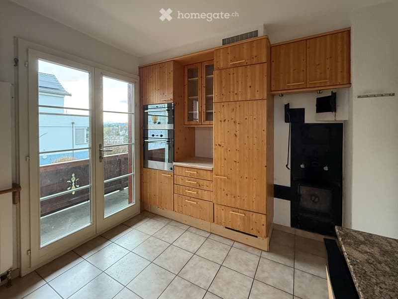 kitchen with large glass doors to balcony, oak cabinets, double oven, fireplace