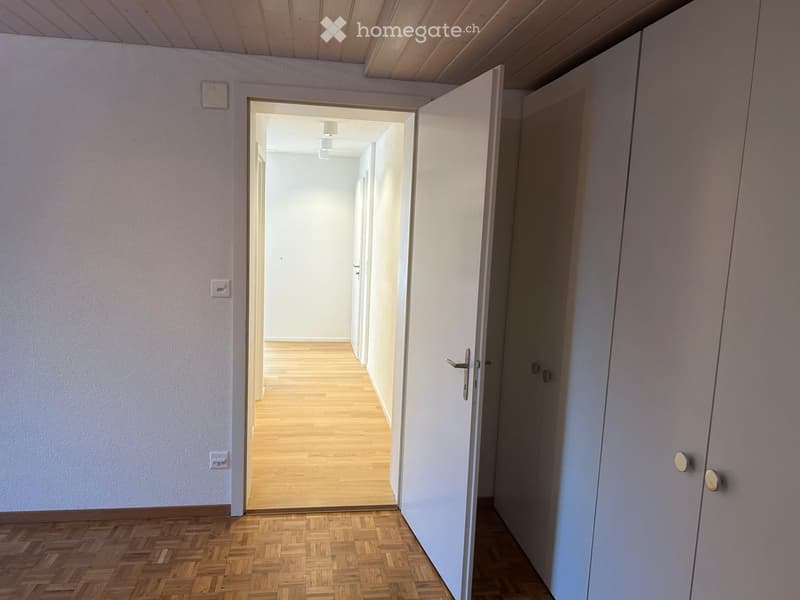 empty room, hallway, wooden floor, white walls, white door, open door