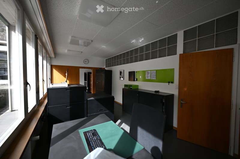 desk with computer keyboard, windows, cabinets, wooden door