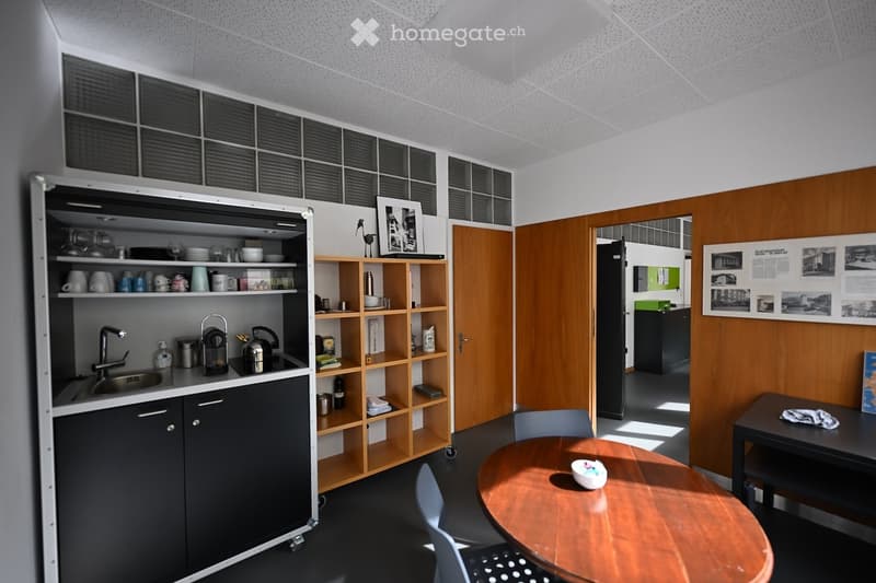 small kitchen area, sink, shelves, wooden desk, chair, picture on wall