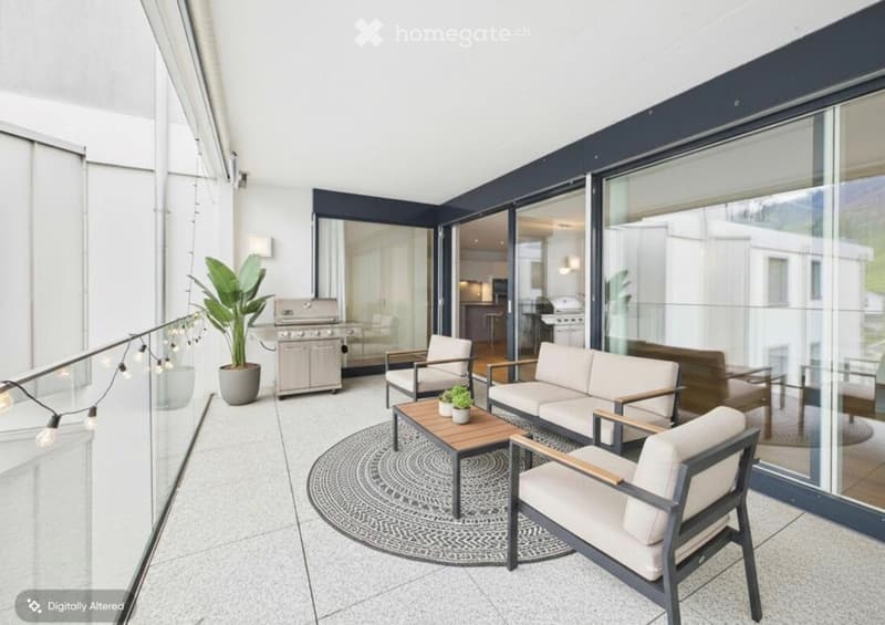Modern balcony with large glass walls, white sofa, coffee table, chairs, potted plants, and a grill.
