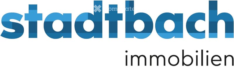 Logo of a real estate company with the text "stadtbach immobilien" in blue and black.