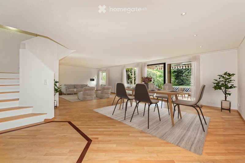 Open-plan living and dining area with wooden flooring, modern furniture, large windows, and a staircase leading to an upper level.