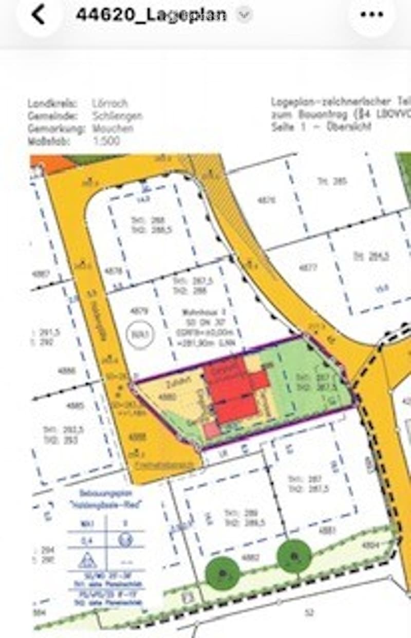 Floor plan of a residential area showing multiple plots, buildings, and designated zones including residential, commercial, and green spaces.