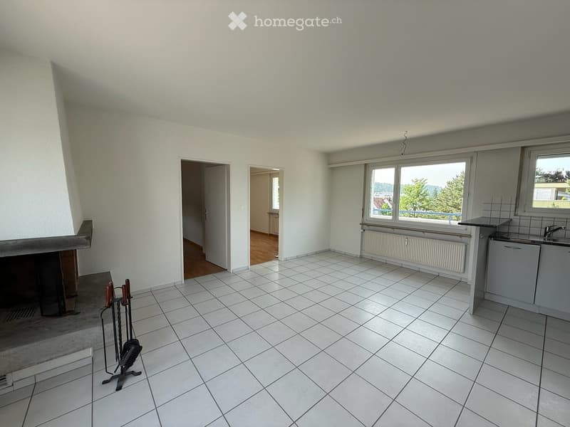 Empty room with white tiled floor, fireplace, radiator, and two doors leading to other rooms.