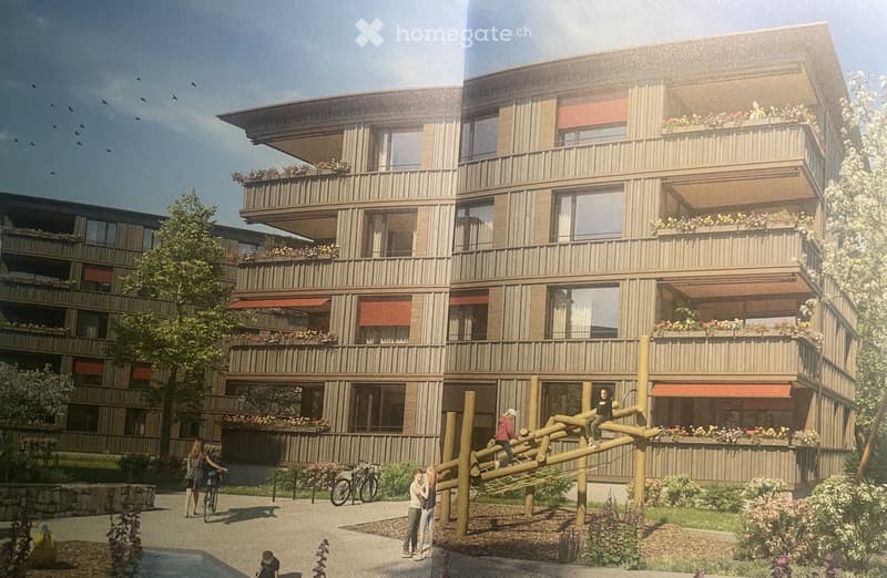 Modern multi-story residential building with balconies, greenery, and a playground area in front.