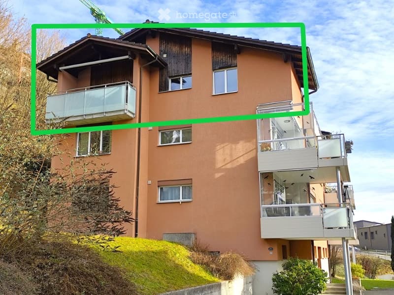 3 story building, brown exterior, multiple balconies, windows, green grass, plants