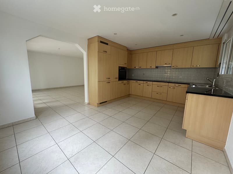 empty kitchen with white tiles, wooden cabinets, black countertops, stainless steel sink, oven, dishwasher