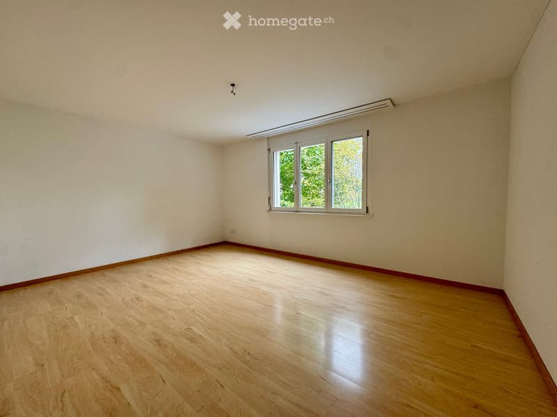 empty room, wooden floor, white walls, window with view to outside