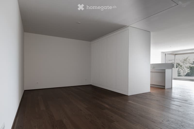 Completely empty room with bare walls and wooden floor. No furniture or equipment.