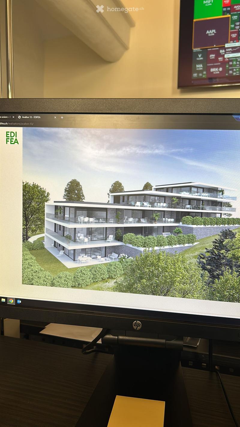 A 3D rendering of a modern two-story house with large windows, balconies, and outdoor seating areas, displayed on a computer screen.