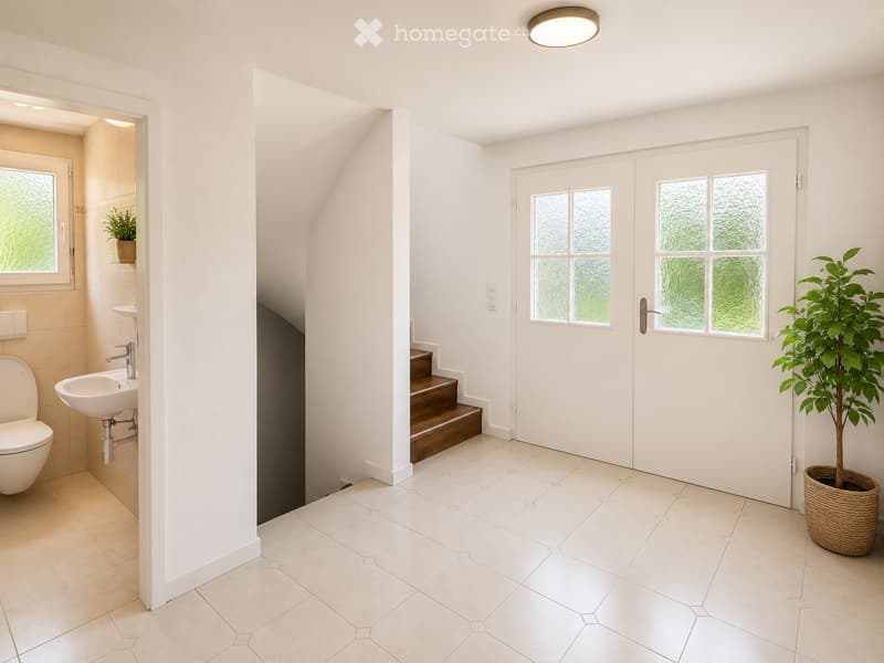 Modern bathroom with white tiled floor, white walls, a toilet, sink, and a small plant in a wicker pot near the door.