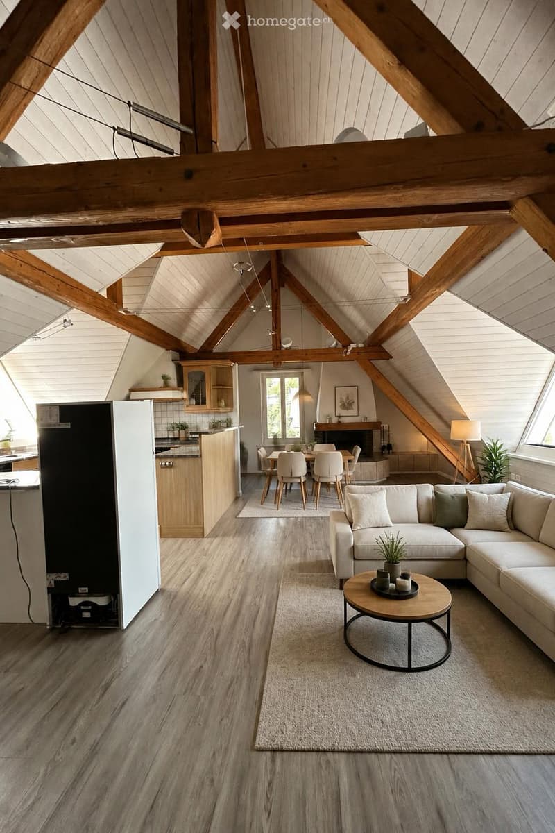Open-plan living and dining area with exposed wooden beams, a modern sofa, coffee table, dining table with chairs, and a small kitchen area with cabinets and a refrigerator.